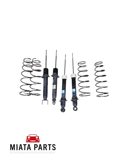 Miata Parts NZ used MX5 NC shock and spring set including four black coil springs and four shock absorbers.